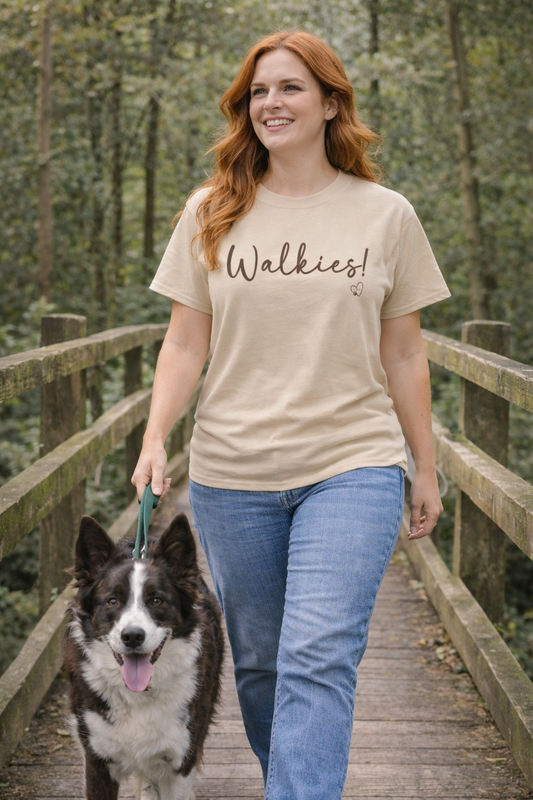 Woman walking a dog on a wooden bridge with 'Walkies!' t-shirt