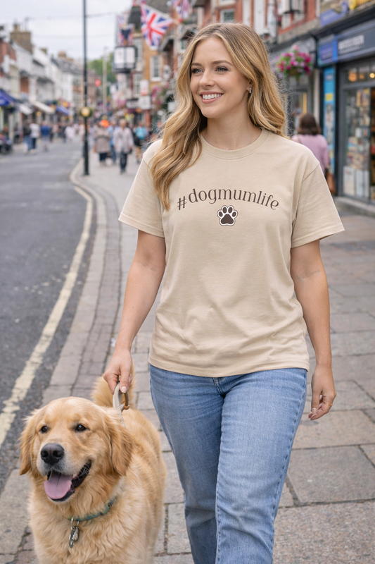Woman walking a dog on a city street wearing a '#dogmumlife' t-shirt.